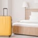 suitcase next to hotel bed